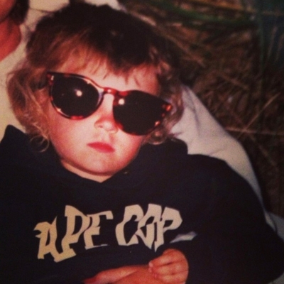 Childhood photo of BrandFuel employee Bre Gentile wearing sunglasses.