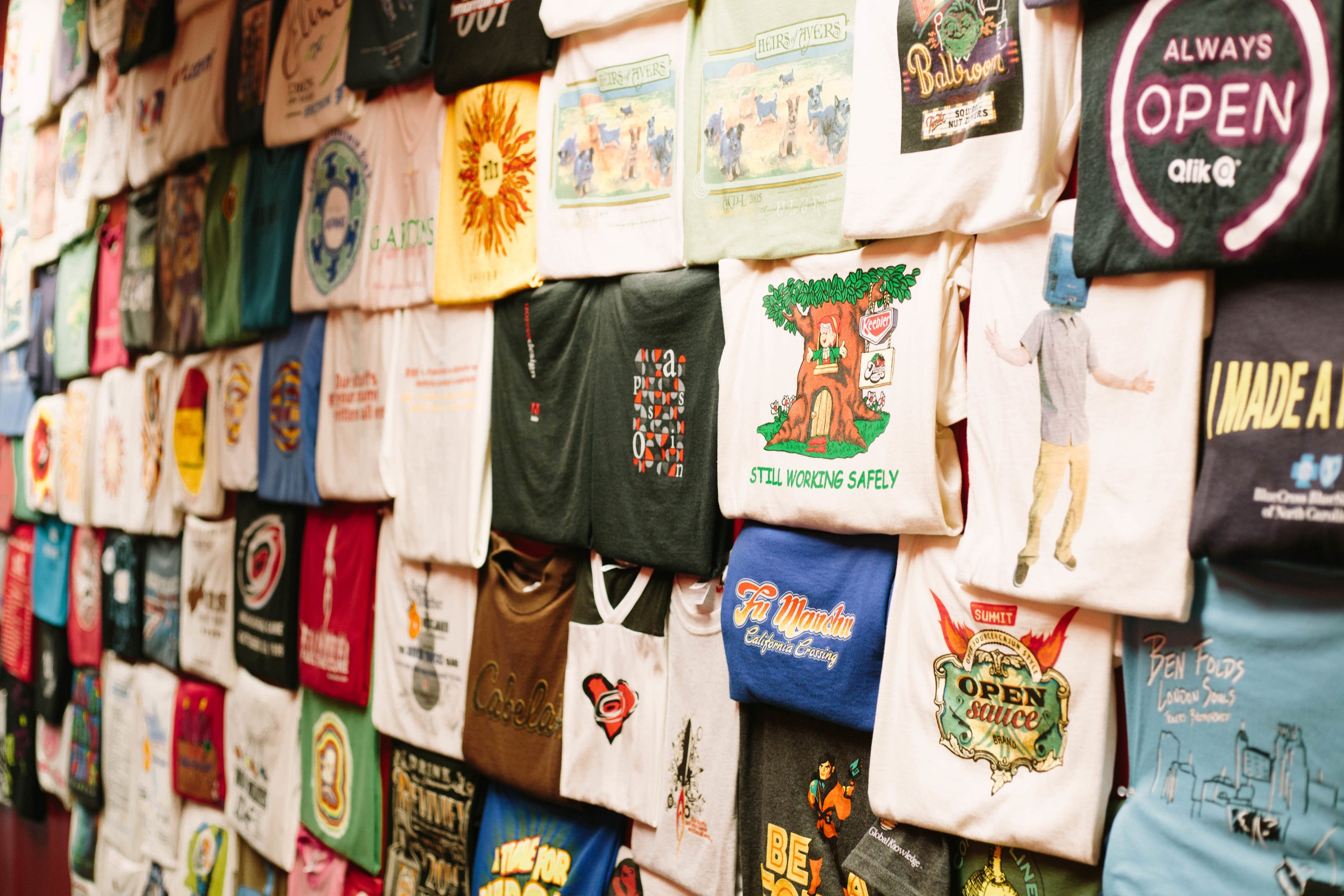 Wall of t-shirts with different designs and colors