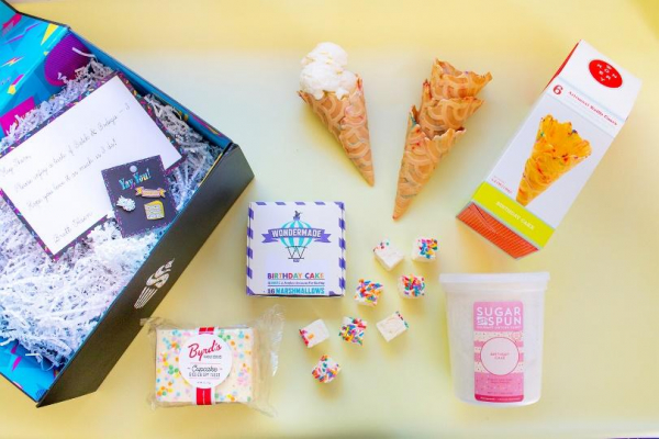 A gift box with ice cream cones and candy.